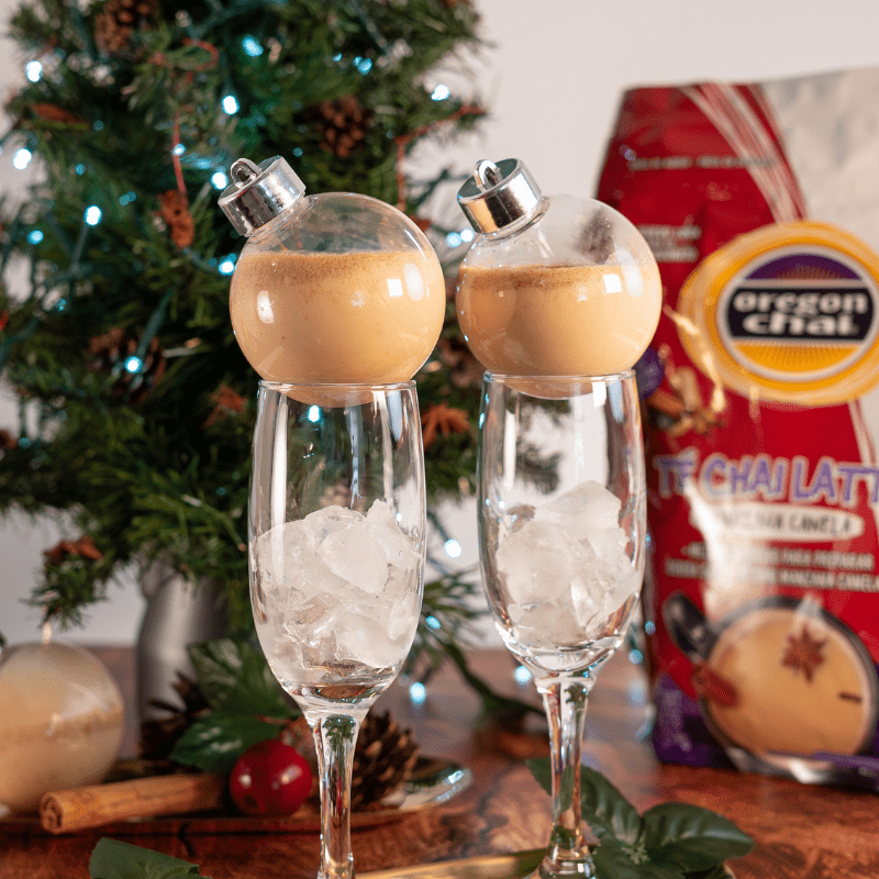 Chai Fera navideño con Oregon Chai Manzana Canela y leche. Servido en esfera decorativa sobre hielo. Sabor cálido, original y festivo.