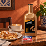 Salsa DaVinci Cajeta Botella 1/2 Galón en escena de cafetería con letrero KEX al centro